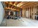 Unfinished basement with framing ready for customization, including a workout area with equipment at 5963 Wild River Vw, Sugar Hill, GA 30518