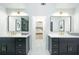 Bright bathroom featuring double sinks, gold hardware, and a doorway view into a bedroom at 5963 Wild River Vw, Sugar Hill, GA 30518