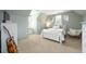 Bedroom features a white bed frame, neutral walls, and a window seat at 5963 Wild River Vw, Sugar Hill, GA 30518