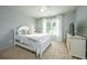 Cozy bedroom with light grey walls, a white bed frame, and a window at 5963 Wild River Vw, Sugar Hill, GA 30518