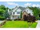Charming two-story home with stone accents, beautiful landscaping, and a well-manicured lawn at 5963 Wild River Vw, Sugar Hill, GA 30518