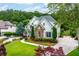 Charming two-story home featuring stone accents, manicured landscaping, and a long driveway at 5963 Wild River Vw, Sugar Hill, GA 30518