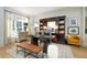 Elegant home office featuring a large desk, custom shelving, and stylish decor at 5963 Wild River Vw, Sugar Hill, GA 30518