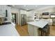 Modern kitchen featuring white cabinets, stainless steel appliances, and an island with bar stool seating at 5963 Wild River Vw, Sugar Hill, GA 30518
