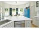 Sun-drenched kitchen nook with stainless steel appliances, white cabinets, and a charming sitting area at 5963 Wild River Vw, Sugar Hill, GA 30518