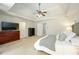 Comfortable main bedroom with a ceiling fan, neutral carpeting and decor, and a large dresser at 5963 Wild River Vw, Sugar Hill, GA 30518