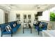 Comfortable porch seating with stylish blue and white striped cushions and ceiling fans at 5963 Wild River Vw, Sugar Hill, GA 30518
