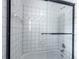 Close up of the white tiled shower and glass door at 5963 Wild River Vw, Sugar Hill, GA 30518