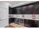 Modern bar area featuring sleek black cabinets, white countertops, and stylish beverage cooler at 629 2Nd Avenue, Decatur, GA 30030