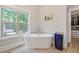 Bright bathroom with a soaking tub, large window, and stylish decor, creating a tranquil and relaxing space at 629 2Nd Avenue, Decatur, GA 30030