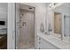 Contemporary bathroom with glass-enclosed shower, neutral tiles, a vanity with marble countertops, and modern fixtures at 629 2Nd Avenue, Decatur, GA 30030