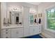 Bright bathroom features double vanity, modern fixtures and a large window with lush green views at 629 2Nd Avenue, Decatur, GA 30030