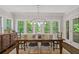 Elegant dining room bathed in natural light, featuring a spacious wooden table, neutral decor and multiple windows at 629 2Nd Avenue, Decatur, GA 30030