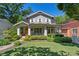Charming two-story home featuring a covered front porch, manicured lawn and lush landscaping at 629 2Nd Avenue, Decatur, GA 30030