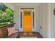 Bright orange front door with glass panels, welcoming guests onto a charming front porch at 629 2Nd Avenue, Decatur, GA 30030