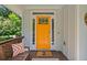 The bright orange front door adds a welcoming pop of color to the entry of this lovely home at 629 2Nd Avenue, Decatur, GA 30030