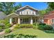Charming gray two-story home featuring a well-manicured lawn, lush landscaping, and inviting front porch at 629 2Nd Avenue, Decatur, GA 30030