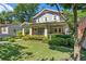 Charming gray two-story home featuring a well-manicured lawn, lush landscaping, and inviting front porch at 629 2Nd Avenue, Decatur, GA 30030