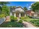 Inviting two-story home with a covered front porch, manicured lawn, and vibrant landscaping at 629 2Nd Avenue, Decatur, GA 30030