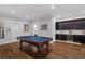 Spacious game room features a pool table, hardwood floors, and a convenient bar area with custom cabinetry at 629 2Nd Avenue, Decatur, GA 30030