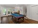 Spacious game room with a pool table, hardwood floors, and natural light at 629 2Nd Avenue, Decatur, GA 30030
