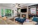 Cozy living room featuring fireplace, built-in bookshelves, a ceiling fan, and access to outdoor porch at 629 2Nd Avenue, Decatur, GA 30030