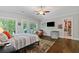 Serene main bedroom with hardwood flooring, walk-out to deck, vaulted ceilings, and a spacious walk-in closet at 629 2Nd Avenue, Decatur, GA 30030