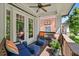 Cozy outdoor living space with comfortable seating and ceiling fan on a covered porch at 629 2Nd Avenue, Decatur, GA 30030