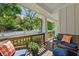 Inviting covered porch with wood railing, comfortable seating and neighborhood views at 629 2Nd Avenue, Decatur, GA 30030