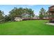 A large well-manicured lawn in the backyard with a garden shed, plants, and privacy fence at 909 Shatley Dr, Stockbridge, GA 30281