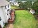 Large backyard features a spacious lawn, wooden deck, shed, and privacy fence at 909 Shatley Dr, Stockbridge, GA 30281
