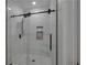 Modern bathroom featuring a shower with tile surround, rainfall shower head, and glass door at 909 Shatley Dr, Stockbridge, GA 30281