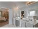 Bright bathroom with double vanity, large mirror, soaking tub, and walk-in shower at 909 Shatley Dr, Stockbridge, GA 30281