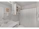 Neutral bathroom features a shower/tub combination with white curtain, vanity, and a built in shelving unit at 909 Shatley Dr, Stockbridge, GA 30281