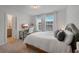 Cozy bedroom with desk, white bedding, and bright natural light at 909 Shatley Dr, Stockbridge, GA 30281