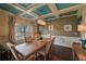 Inviting dining room featuring a coffered ceiling and a large dining table with seating for six at 909 Shatley Dr, Stockbridge, GA 30281