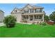 Beautiful two-story home with a manicured lawn, flowering plants, and a cozy front porch at 909 Shatley Dr, Stockbridge, GA 30281