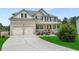 Charming two-story brick home with a well-manicured front yard and two-car garage at 909 Shatley Dr, Stockbridge, GA 30281