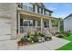 Close-up of a beautiful home's front porch adorned with flowers and lush landscaping at 909 Shatley Dr, Stockbridge, GA 30281