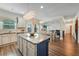 Bright kitchen with granite countertops, stainless steel appliances, and a large center island at 909 Shatley Dr, Stockbridge, GA 30281