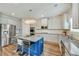 Modern kitchen with granite countertops, stainless steel appliances, and a blue center island at 909 Shatley Dr, Stockbridge, GA 30281