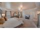 Large main bedroom featuring a tray ceiling, chandelier, and carpeted floors at 909 Shatley Dr, Stockbridge, GA 30281