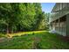 Beautiful backyard featuring green grass, tall trees, and a multilevel deck, perfect for outdoor relaxation at 1010 Longcreek Pointe, Alpharetta, GA 30005