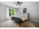 This is a bedroom with a ceiling fan, a black bed frame, and carpeted floors at 1010 Longcreek Pointe, Alpharetta, GA 30005