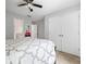 This is a bedroom with a ceiling fan, a double door closet, and carpeted floors at 1010 Longcreek Pointe, Alpharetta, GA 30005