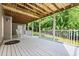 The outdoor deck features wooden ceiling and white railings that add classic detail to its design at 1010 Longcreek Pointe, Alpharetta, GA 30005