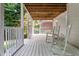 View of the deck area featuring a white railing, wooden ceiling, and cozy rocking chairs at 1010 Longcreek Pointe, Alpharetta, GA 30005