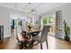 Elegant dining room with hardwood floors, contemporary lighting, and a dining table at 1010 Longcreek Pointe, Alpharetta, GA 30005