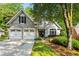 Charming stucco home with a two-car garage and beautifully landscaped front yard at 1010 Longcreek Pointe, Alpharetta, GA 30005