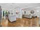 Open kitchen connects to dining and living areas, showcasing an island, hardwood floors, and modern design at 1010 Longcreek Pointe, Alpharetta, GA 30005